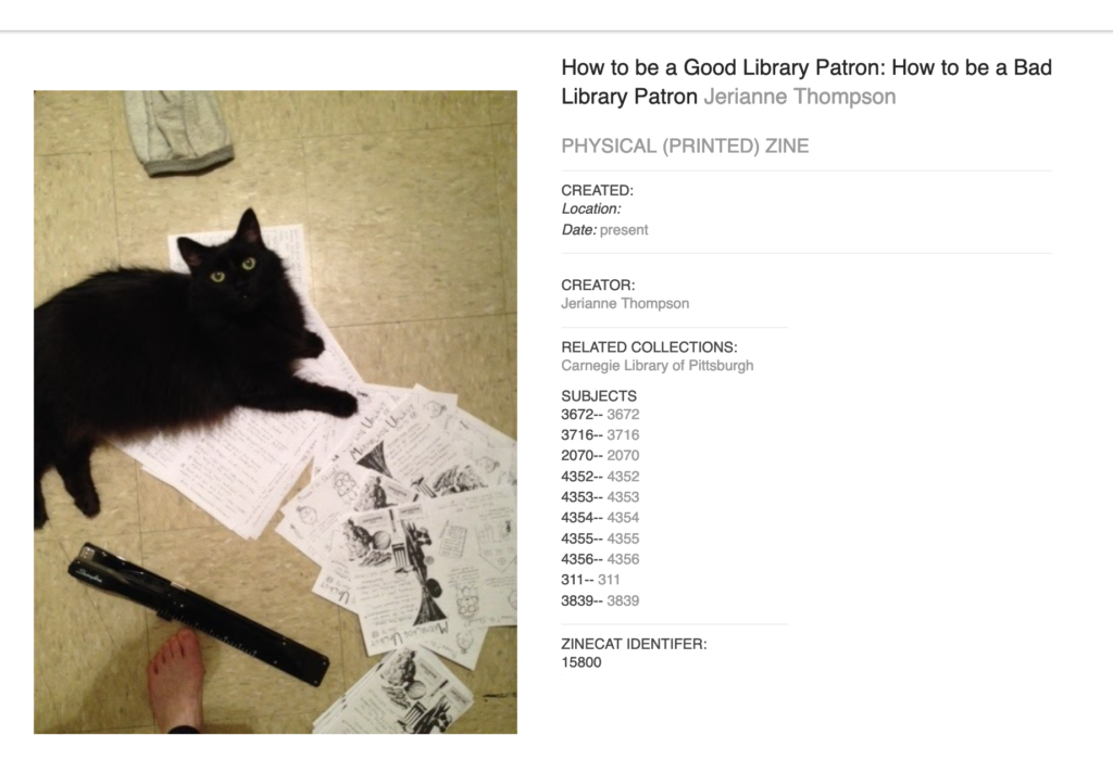 photo of cat on zine pages with a long-armed stapler and a human's foot. Catalog record for How to be a Good Library Patron: How to be a Bad Library Patron zine by Jerianne Thompson.